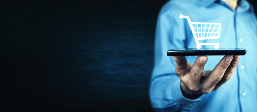 Businessman holding a phone with a shopping icon.
